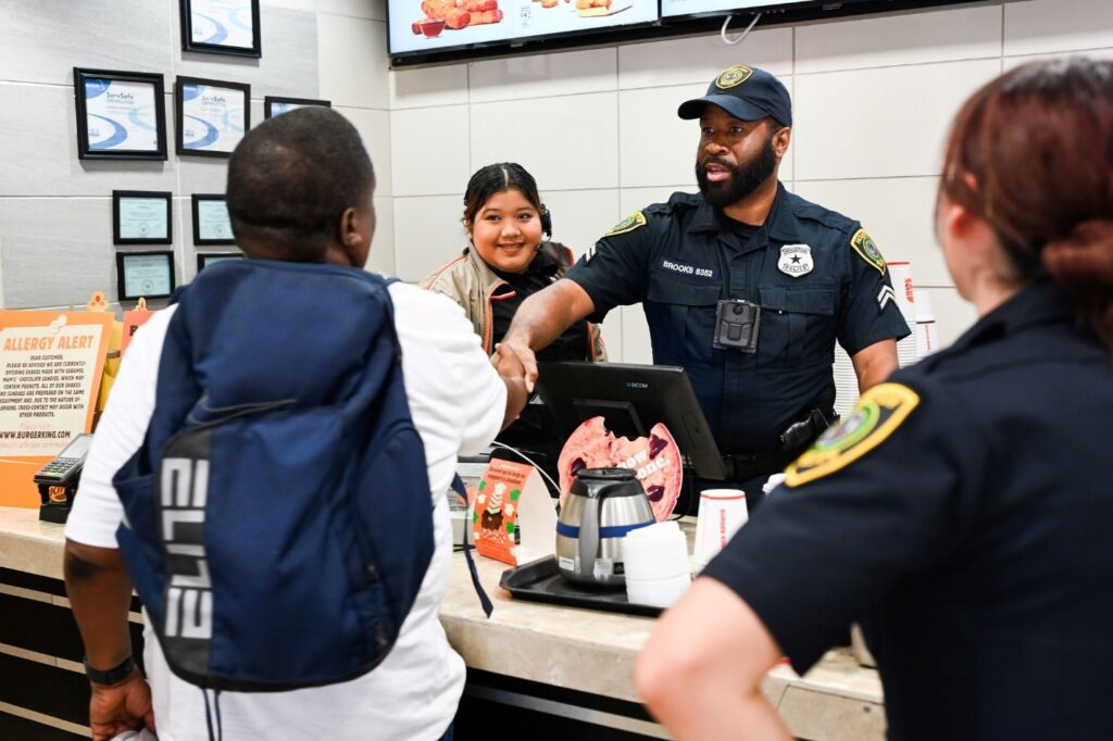 Law enforcement officers and community members engaging in partnership activities for public safety
